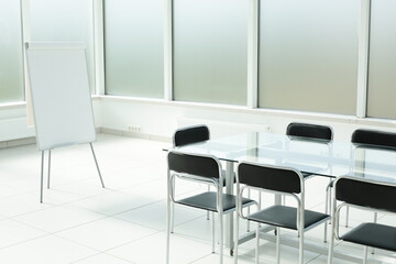 Flipchart glass table chairs in bright office space