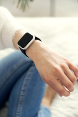 smart watch on a woman's hand. girl looks at smart watch. female hand. technology in devices. clock time