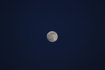 The silver moon on a night backdrop