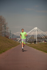 Obraz premium Male sportsman is running while warming up