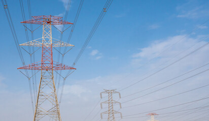 high voltage electric towers during sunset.