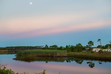 sunset on bay lake with dunes 