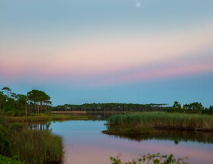 Fototapeta na wymiar sunset on bay lake with dunes 