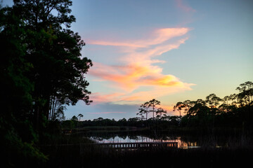sunset on bay lake with dunes 