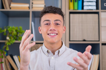 Head shot portrait confident businessman coach wearing glasses looking at camera and talking, mentor speaker holding online lesson, explaining, sitting at wooden work desk in modern cabinet.