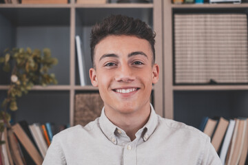 Fototapeta premium Portrait of one young and happy cheerful man smiling looking at the camera having fun. Headshot of male person working at home in the office..