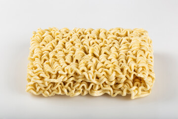 Raw instant noodles on white background.