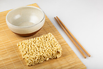 Raw instant noodles on white background.