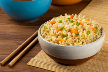 Bowl with instant noodles on the table.