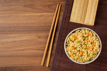 Bowl with instant noodles on the table.