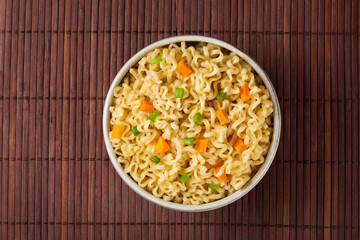 Bowl with instant noodles on the table.