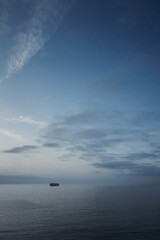 boat over the sea with clouds