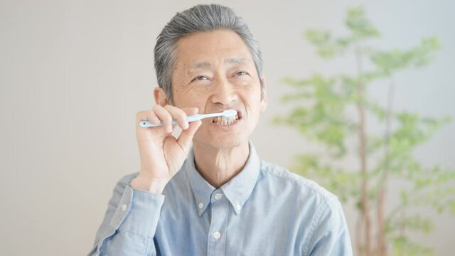 歯磨きをするシニア男性