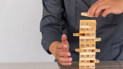 Risk ideas, placing wooden blocks on the table and building business strategies.