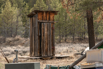 A wood outdoor toilet building at an abandoned homestead in rural Oregon.