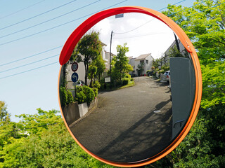 Tokyo,Japan-April 30, 2021: Convex traffic mirror at a road curve in Tokyo, Japan
