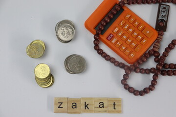 Zakat with coins , prayer beads and calculator