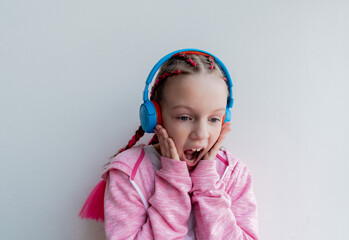 Teenage girl sits on steps near window and records video for blog. Wellness and privacy concept.