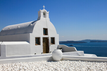 Traditional white church with blue sky and sea, Oia, Santorini, Greece 