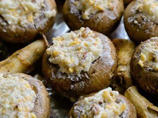 Champignon brown mushrooms stuffed with cheese on a pan prepared for baking