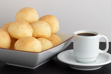 Traditional Brazilian cheese bread (pão de queijo) with a cup of coffee.
