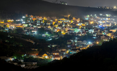 Night scene in the valley bright houses with colorful lights makes the night scene in the countryside more vibrant in the Da Lat plateau, Vietnam