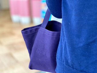 トートバッグを腕にかけて店内を歩く女性