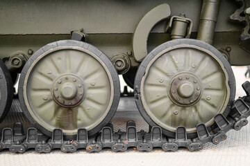 Tank of the Second World War. Track armor close-up. Black track link and large rubberized rollers. Tank chassis. The tank stands on a pedestal.Russia, May 9, 2021. Detail of a tracked tank close-up.