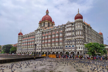The Taj Mahal Palace Hotel in Mumbai, India along with visitor and pigeon