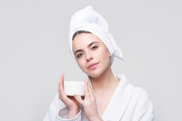 Face beauty care. Portrait of beautiful woman with facial cream in hand. Sexy female with fresh clean soft skin. Cosmetic skincare product.