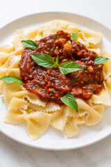 farfalle pasta with basil and garlic in tomato sauce