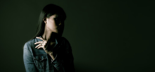 Portrait of female wear many rings over dark green fashion background
