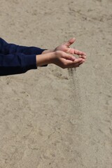 child holding falling sand 