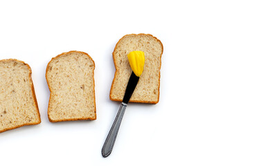 Bread slices with butter on white background.