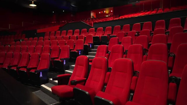 Empty cinema theater, red seats deserted, no shows happening during the Covid-19 Coronavirus pandemic, culture and arts abandoned