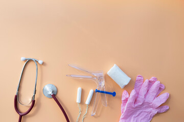 Stethoscope, gloves, medical instruments on a pink background with a copy space.