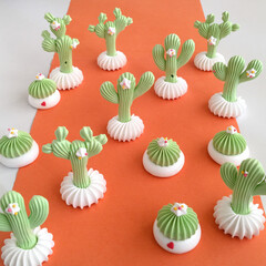 Cute mini cacti meringue on a orange road - obrazy, fototapety, plakaty