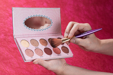 palette of eyeshadow and make up brushes