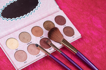 palette of eyeshadow and make up brushes