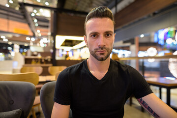 Obraz premium Portrait of handsome man sitting at coffee shop