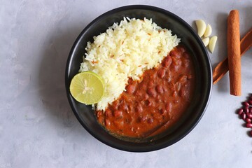 Rajma Chawal is a popular North Indian Food. Rajma is a socked Red kidney beans cooked with onions, tomatoes, and a special blend of spices. Served with Jeera rice or Cumin Rice. With Copy Space.