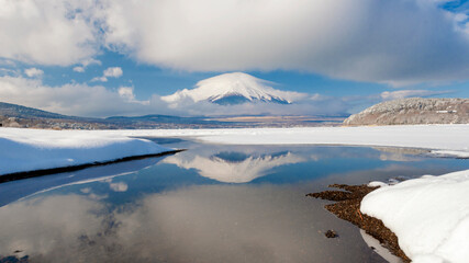 Fuji Mountain covered with Lenticular Cloud and Reflected in Yamanakako Lake in Winter Snow Cloudy Day, Japan