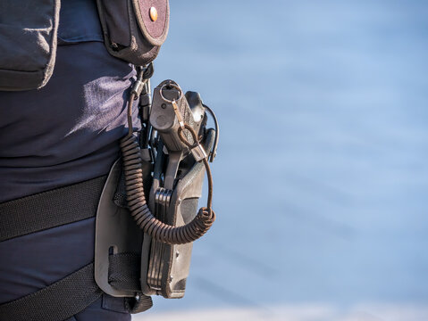 The Gun Or Pistol Of A Romanian Police Officer In Holster. Close Up.