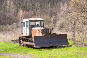 Fototapeta premium old tractor on the grass field