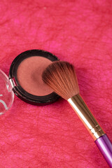 red blush and a make up brush