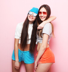 lifestyle and people concept: Two young teenager female friends standing together and having fun.