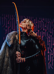 Young girl with sunglasses and fur holding sword