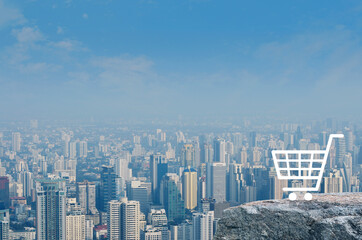 Fototapeta na wymiar Shopping cart flat icon on rock mountain over modern city tower, office building and skyscraper, Business shop online concept