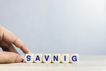 A word "Saving" on table over the light wall. 
