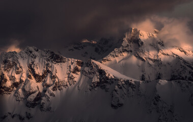 Aerial panorama of dramatic mountain peak and clouds at sunset